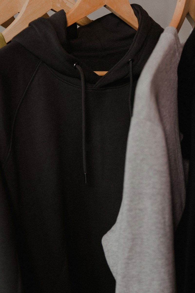 Closet full of black and gray hoodies.