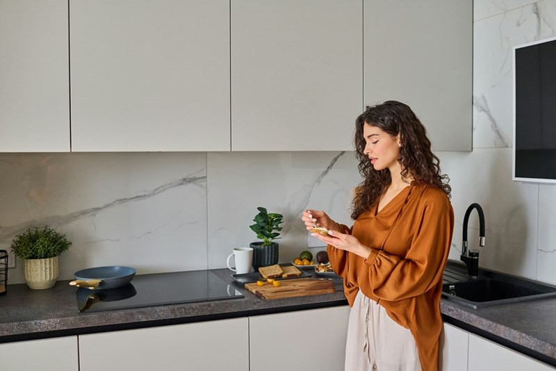Employee makes lunch in an office kitchen.