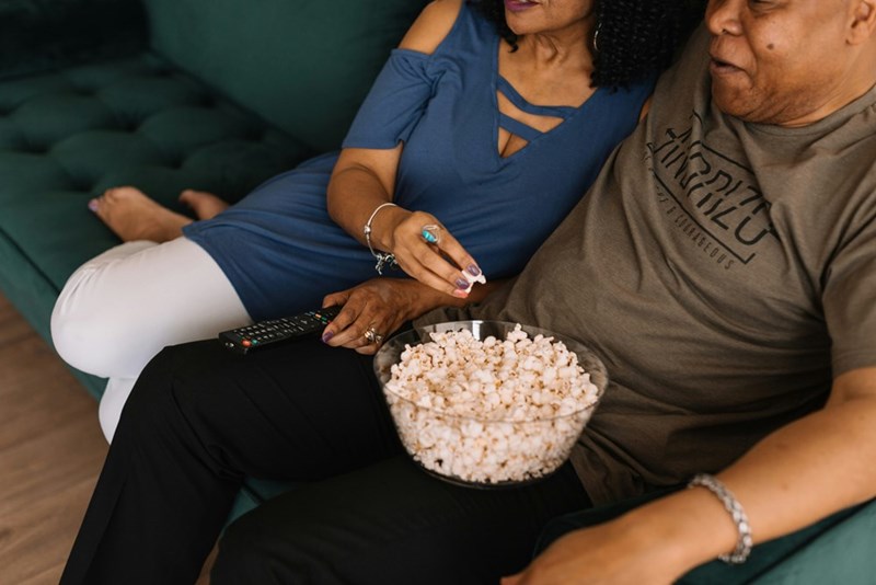 Mixed race couple watching TV