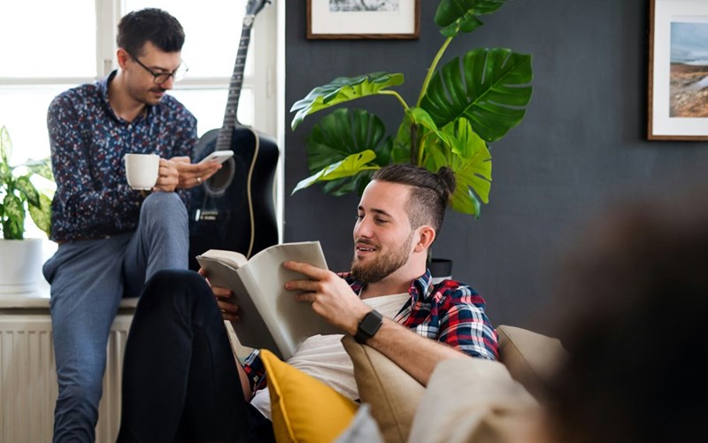 A group of young cheerful friends relaxing indoors