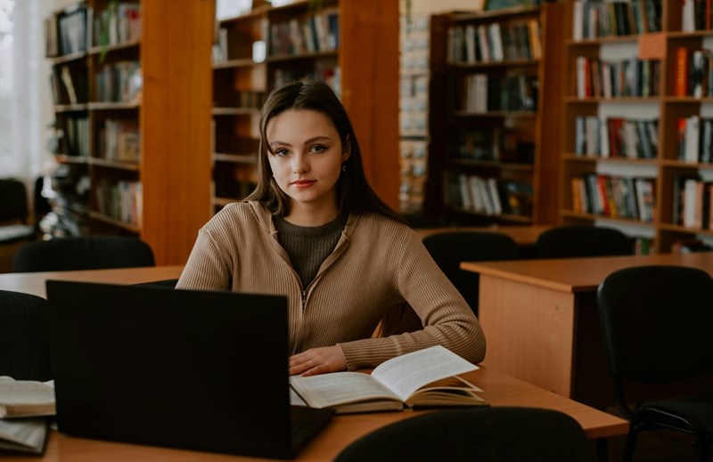 College student sitting in a library