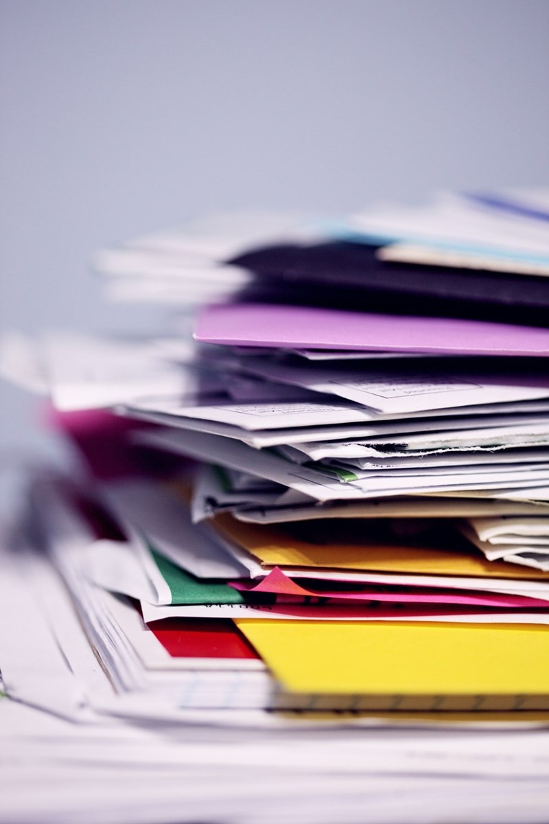 A pile of paperwork in color folders
