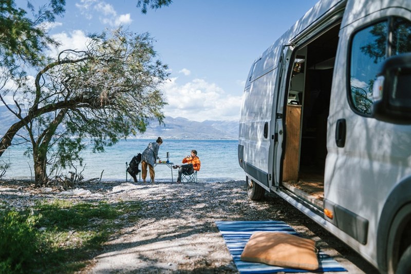 Couple relax at a beachside campsite.