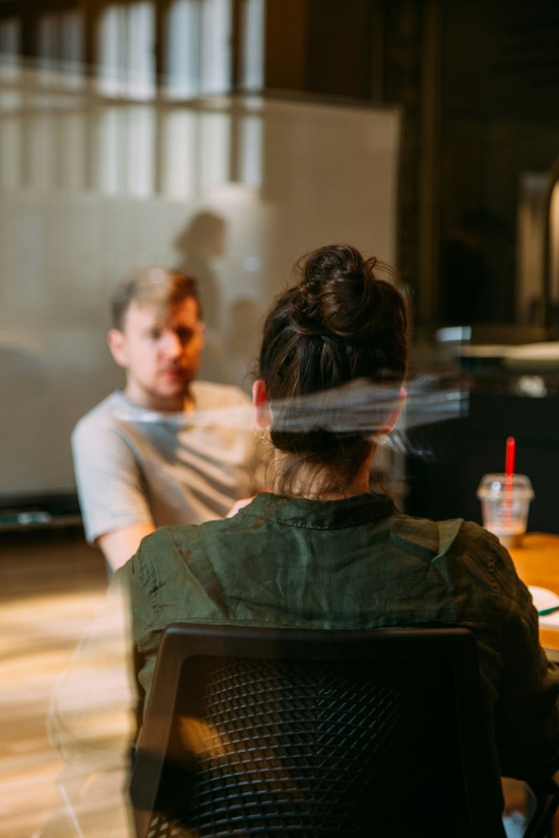 Two people having a meeting inside see-through office