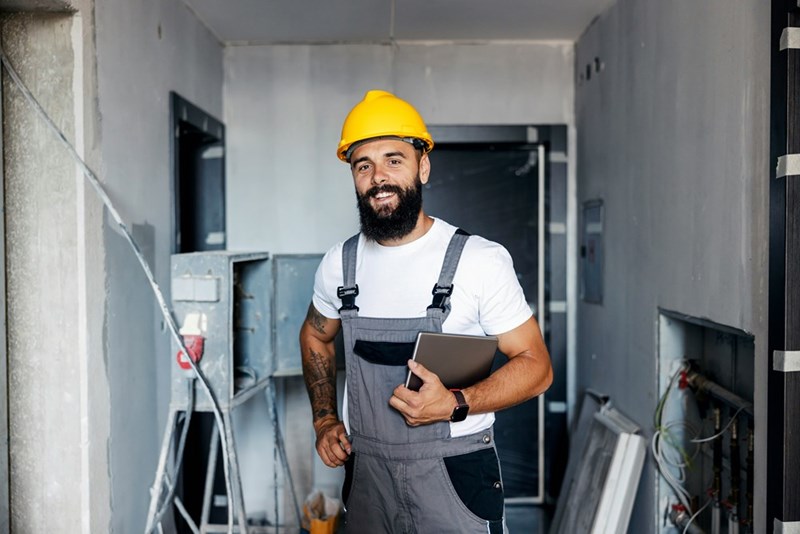 Electrician smiles while at work.