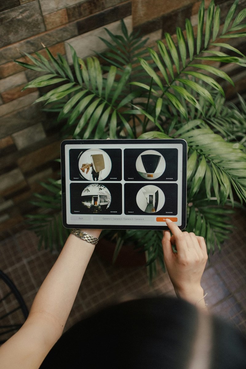 Someone looking on an ipad at security footage capture by their home cameras