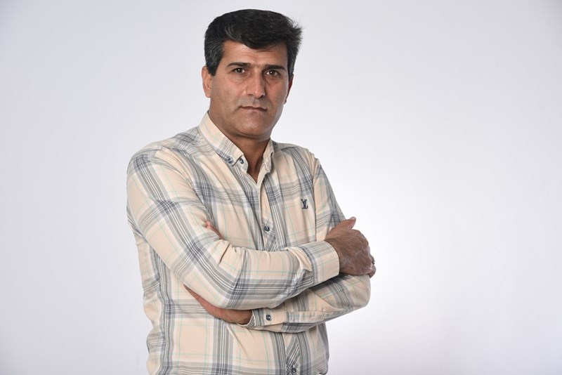 Man in white brown and black plaid button-up shirt