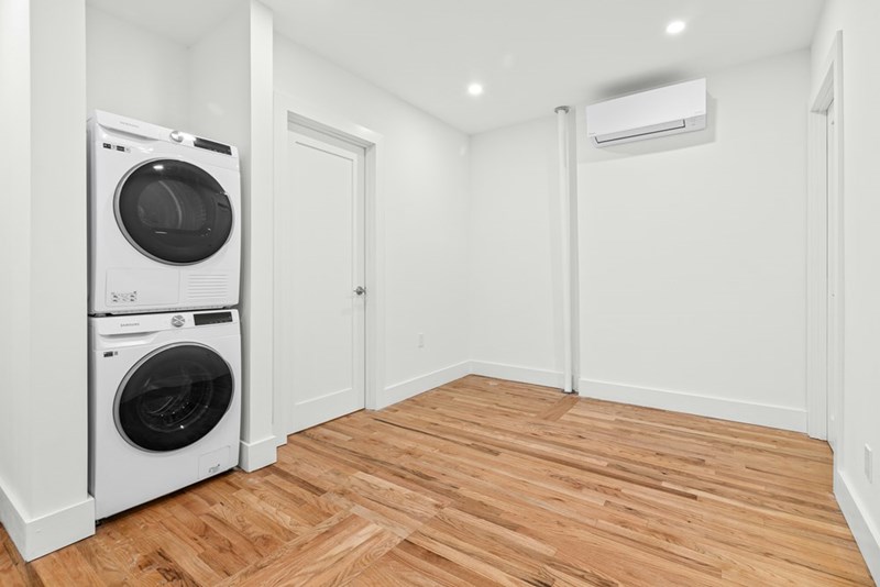 A washer and a dryer in an empty room