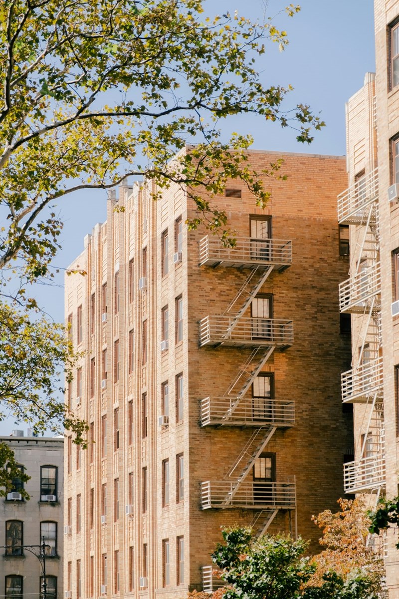 A tall brick building with a fire escape