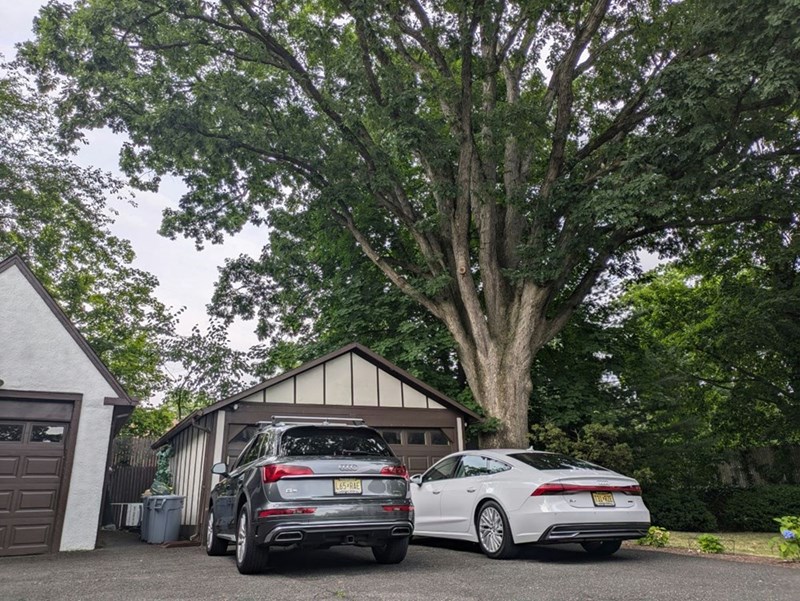 Two cars parked in front of a garage