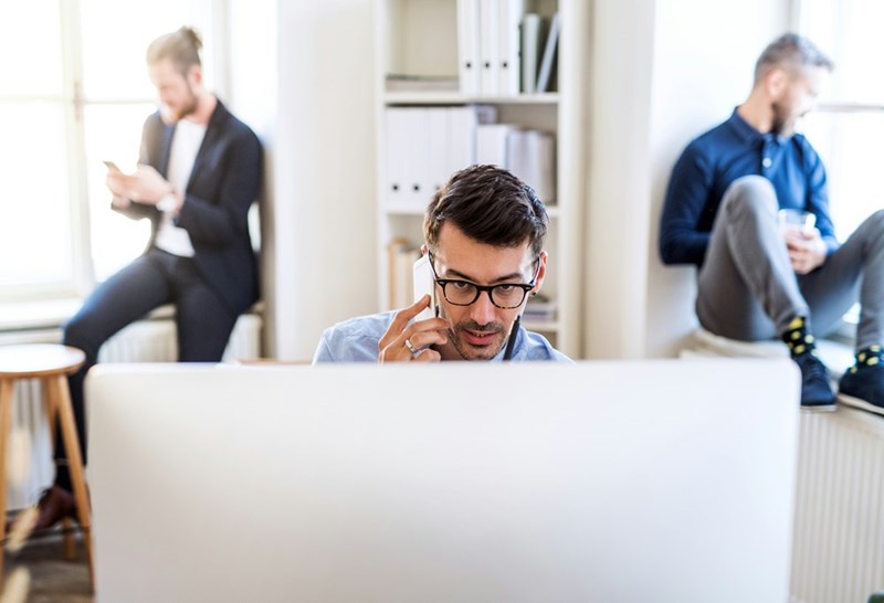 A man looks frustrated behind his desktop
