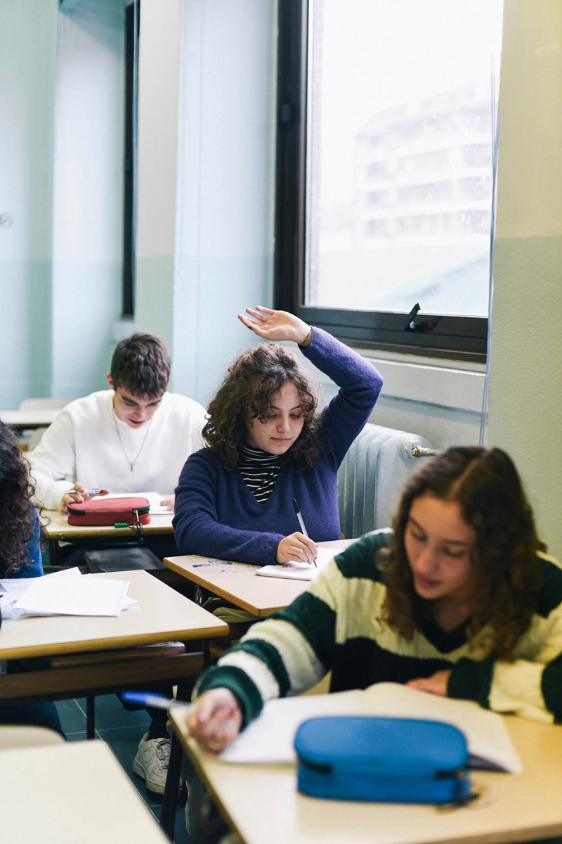 Student raises her hand to ask a question.