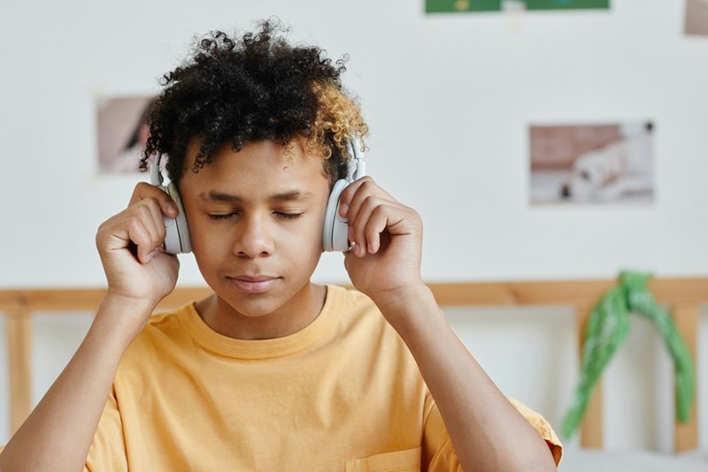 Kid tries to tune out his family members with headphones.