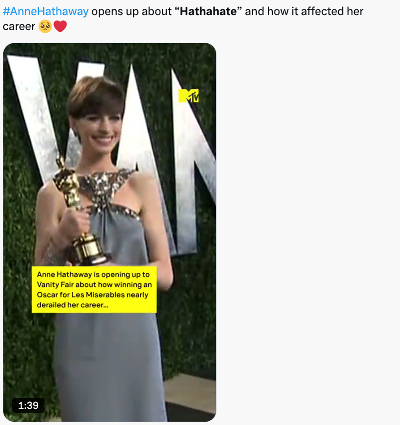 A photograph of Anne Hathaway posing with her Oscar on a red carpet in 2013.