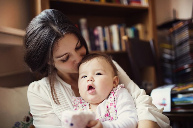 Mother with her baby daughter in the living room