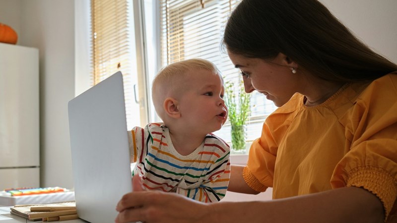 A babysitter reads to a young baby