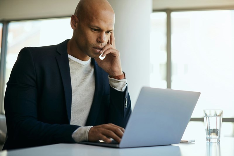 Job candidate concentrates on writing a scathing email.