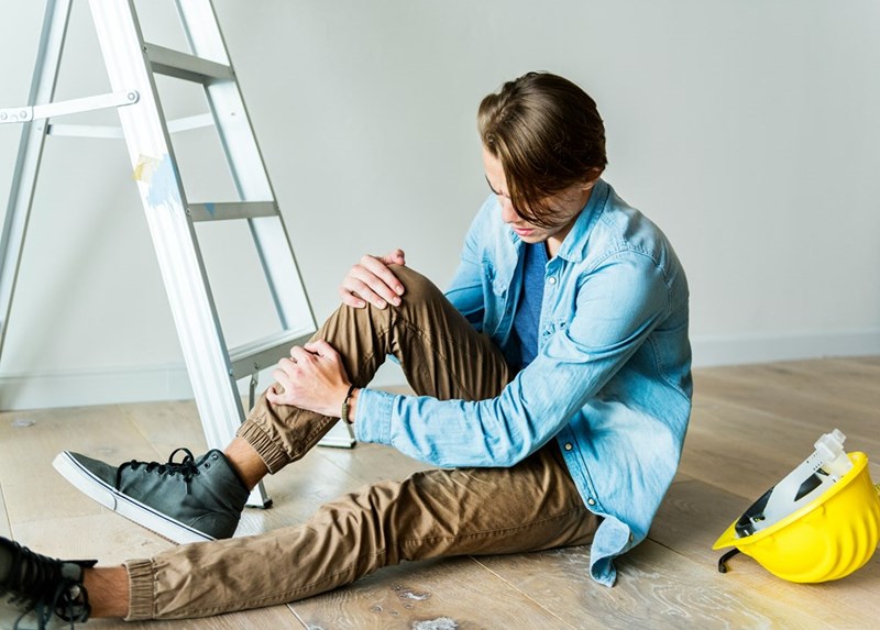 Man falling over and hurting his leg