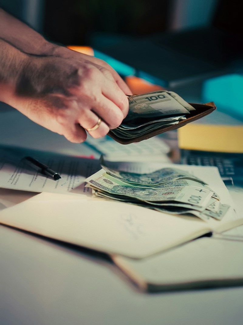 Hands counting $100 dollar bill