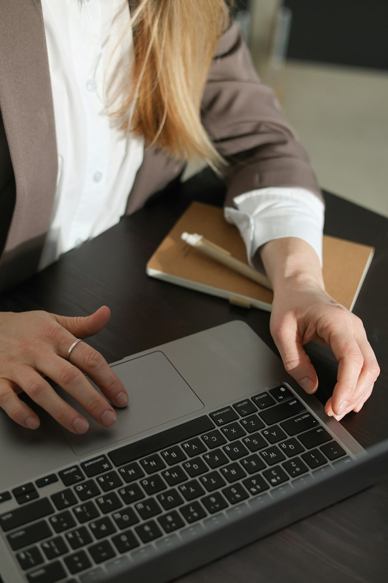 Business professional woman in a suit typing on a laptop computer
