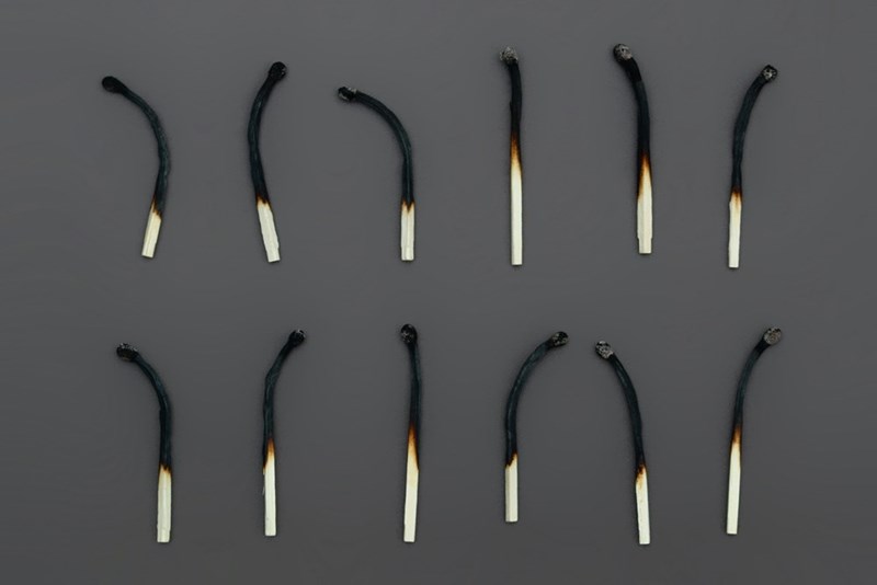 A row of burnt matches, symbolizing burnout