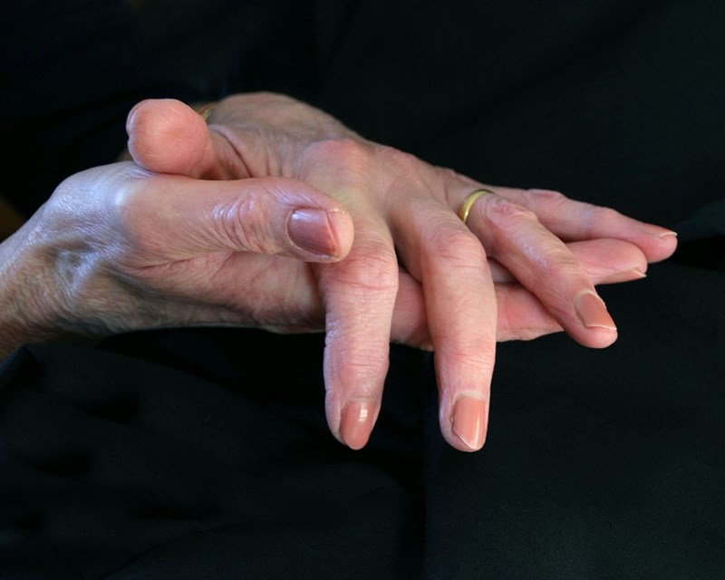 A close-up of a persons hands holding another persons hand