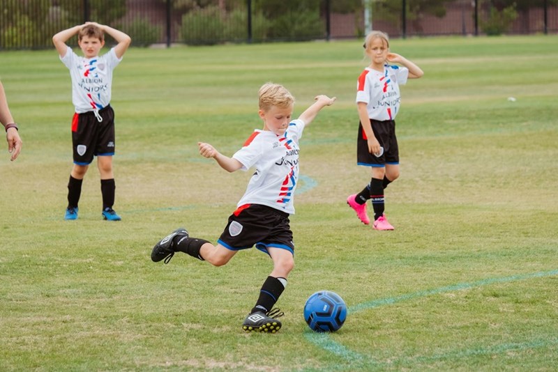 Kids play soccer during an after-school practice that quickly became part of a family scheduling conflict.