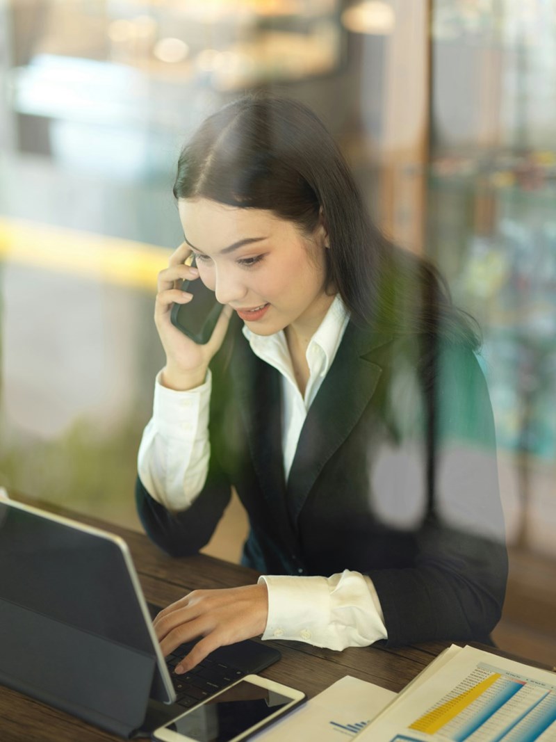 Worker answers her phone, looking nervous.
