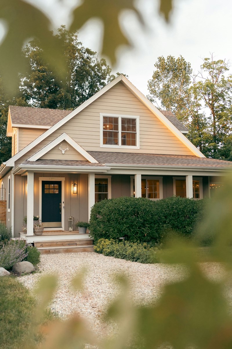 Beautiful house being shown through some shrubbery