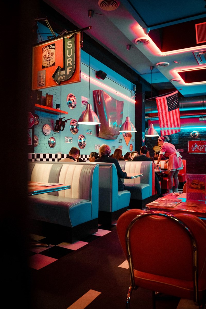 Waitress serves customers at a diner.