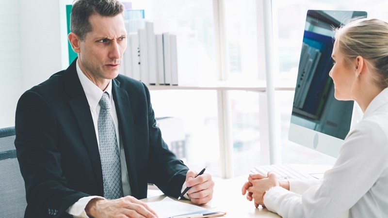 Job seeker in job interview meeting with manager and interviewer at corporate office