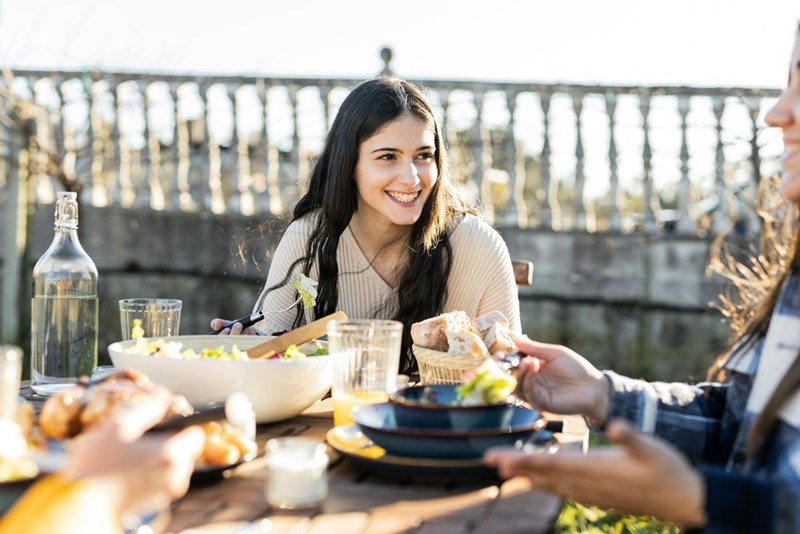 Women eat on a date together.