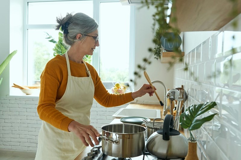 Old mom cooking in a kitchen