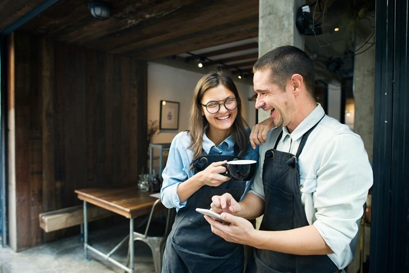 Worker and manager have a laugh once the customer is out of earshot.