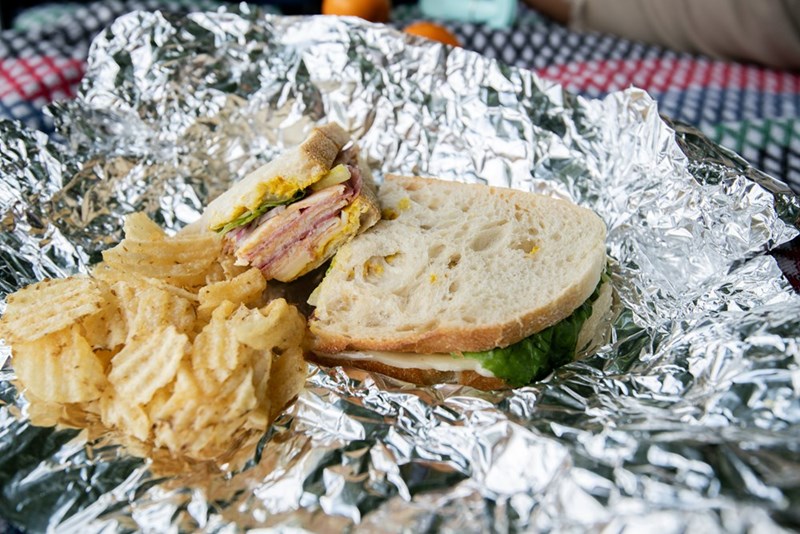 Sandwich and chips on aluminum foil