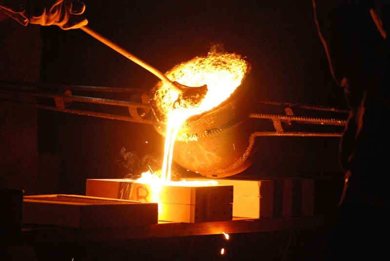 A man is working on a piece of metal