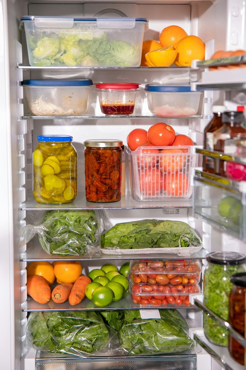 Fridge filled with fruits, vegetables, pickle veggies, and condiments.