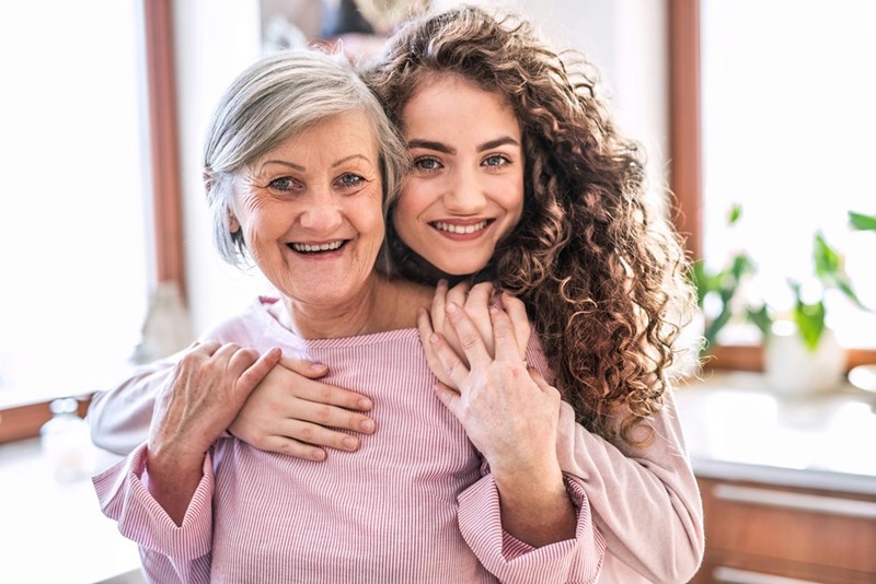 Woman hugs her Mom.