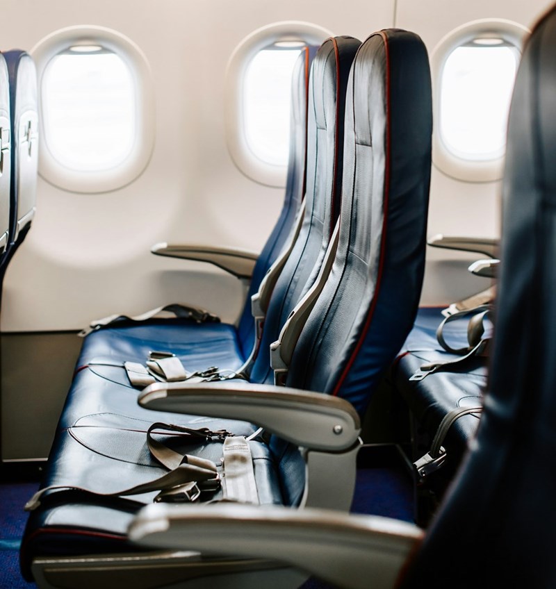 Row of airplane seats with armrests
