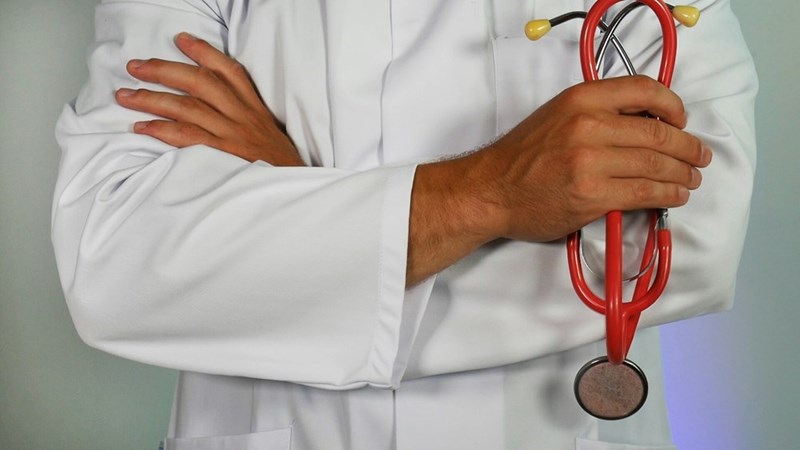 A doctor holds a stethoscope