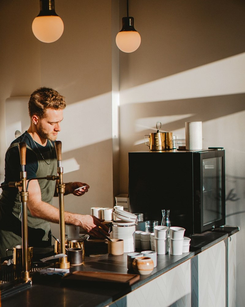Male barista behind the counter