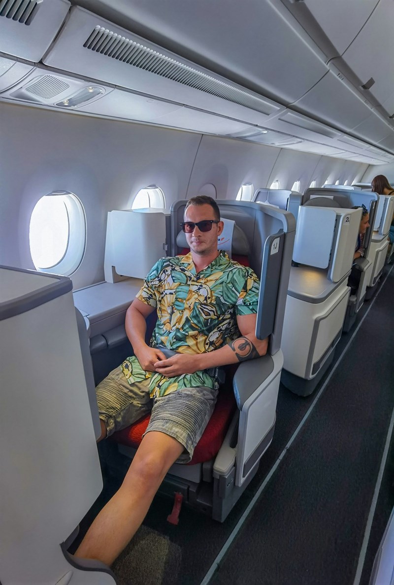 Man sitting in business class seat on an airplane
