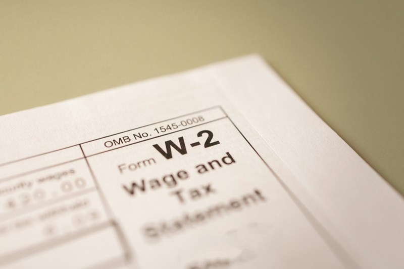 A close-up of a W-2 and tax form
