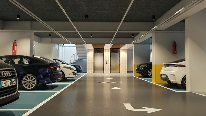 Modern apartment building parking garage with assigned indoor parking spaces and vehicles parked inside
