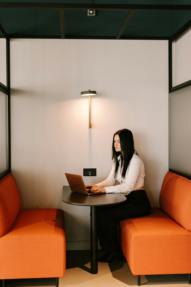 A woman sitting at a table with a laptop