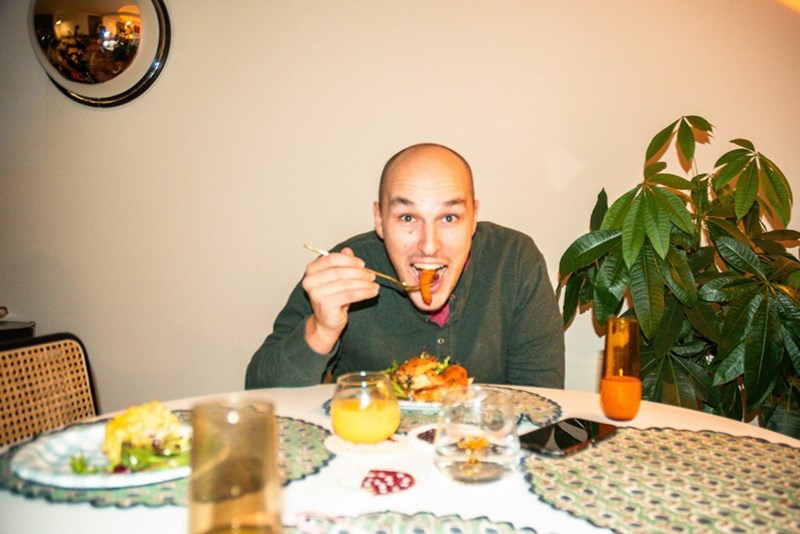 A man sitting at a table with a plate of food in front of him