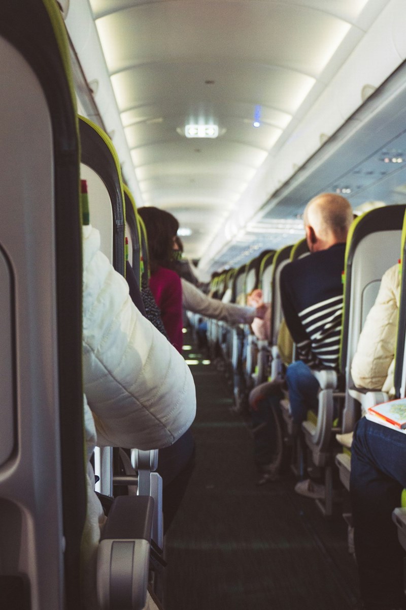 Passengers seated on plane to begin their vacation.