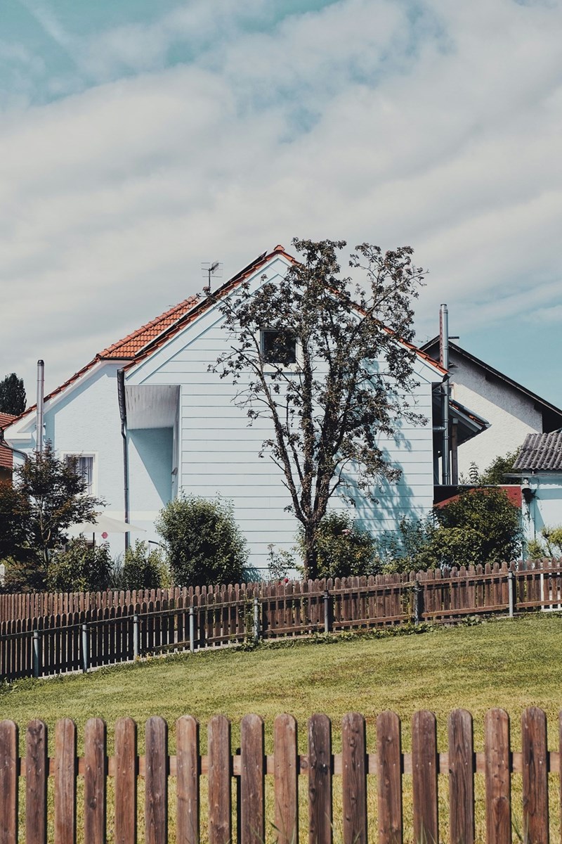 A wooden fence separating neighboring properties.