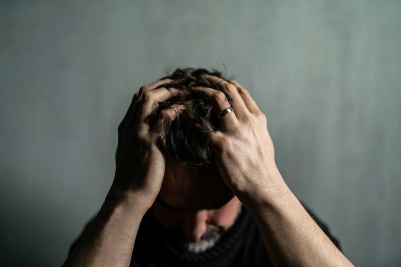 Man feeling defeated after a dispute with a neighbor.