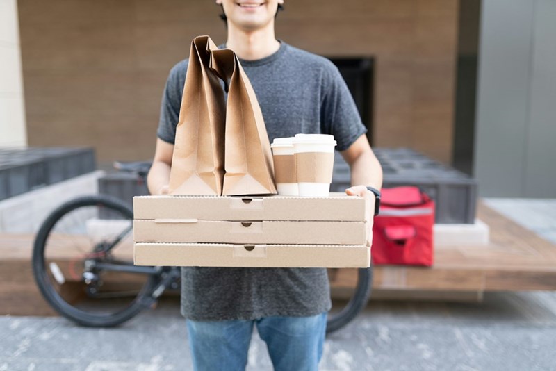 Delivery driver shows up with pizza and coffees for the neighbor's family.